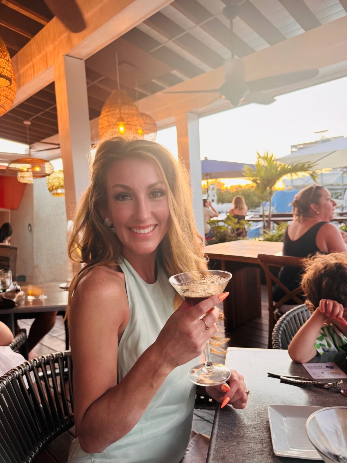 Nikki, creator of The Intentional Kitchen, holding an espresso martini